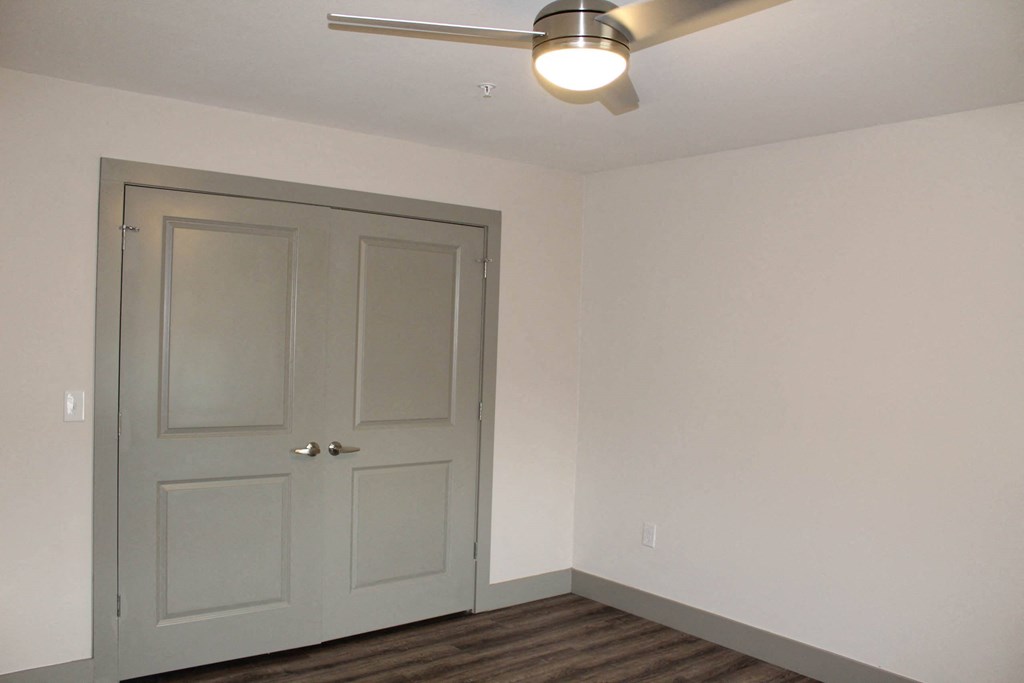 a room with a white door and a ceiling fan  at Haven Homes Apartments, LP, Plainfield, 46168