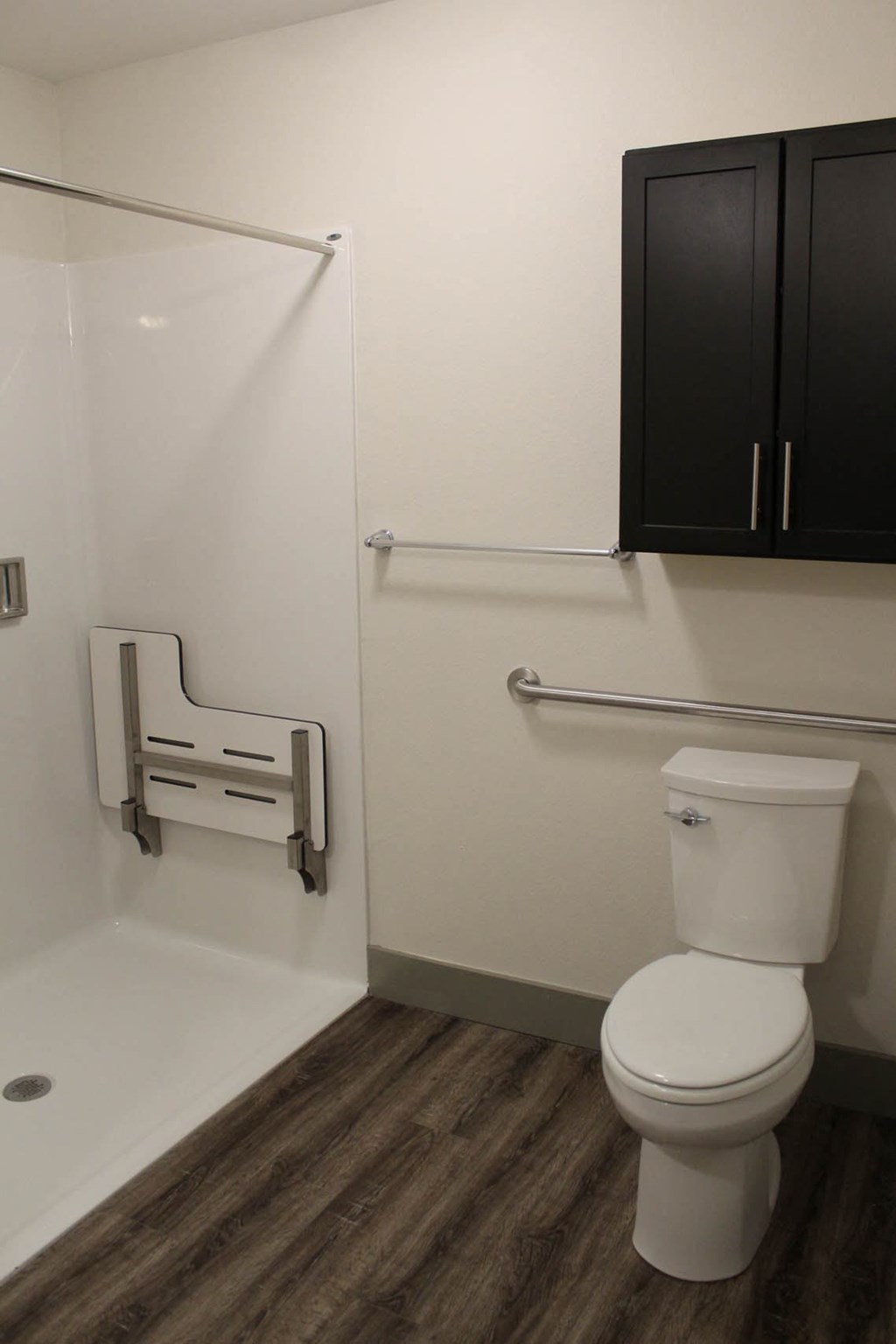 a bathroom with a toilet and a shower in it  at Haven Homes Apartments, LP, Indiana