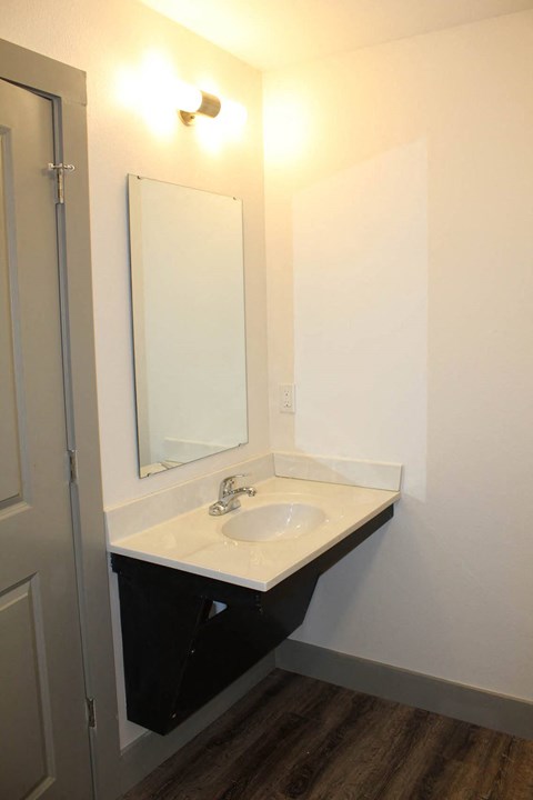 a small bathroom with a sink and a mirror  at Haven Homes Apartments, LP, Plainfield, Indiana