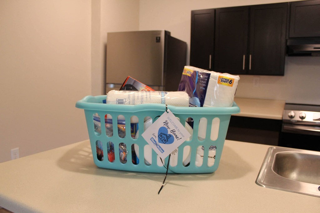 a laundry basket full of items on a kitchen counter  at Haven Homes Apartments, LP, Plainfield, IN