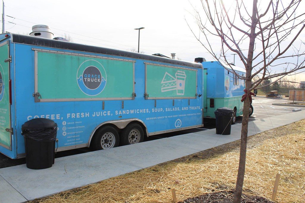 a blue food truck parked next to a sidewalk  at Haven Homes Apartments, LP, Plainfield, 46168