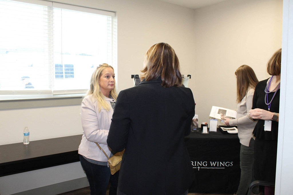 a group of women standing around a table talking  at Haven Homes Apartments, LP, Indiana, 46168