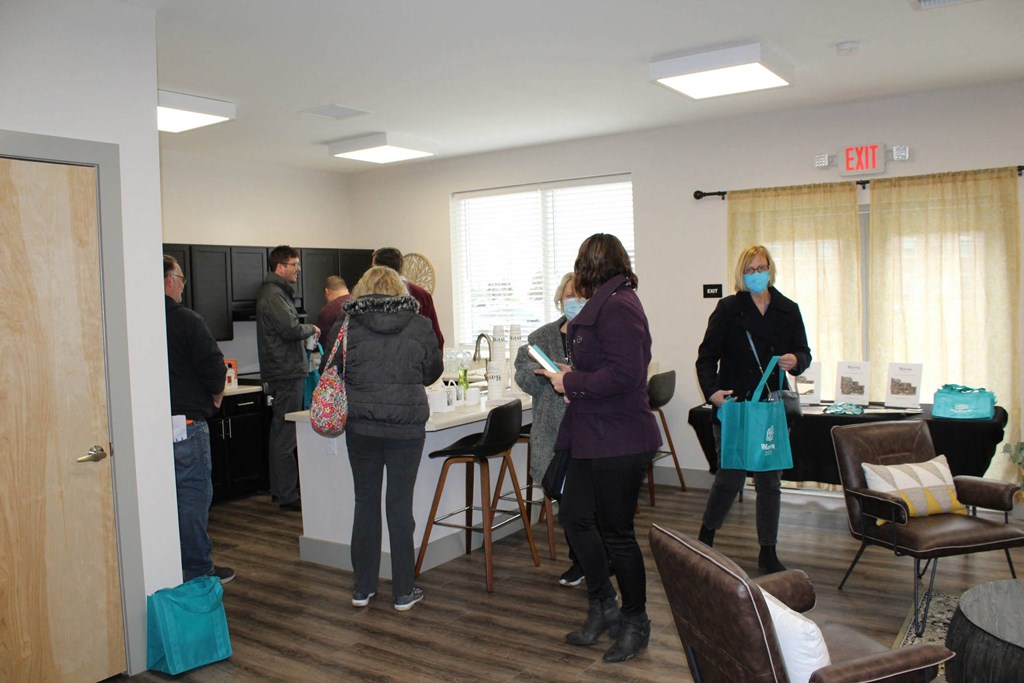 a group of people standing around a counter in a room  at Haven Homes Apartments, LP, Plainfield, IN, 46168