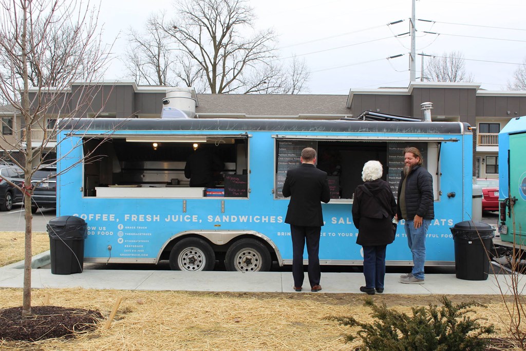 people standing in front of a blue food truck  at Haven Homes Apartments, LP, Plainfield, 46168