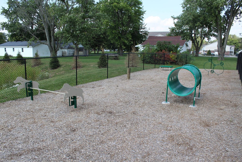 a playground with a swing set and a slide at Salem Place Apartments, Indiana