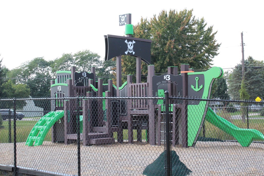 a playground with a large set of playground equipment and slides at Salem Place Apartments, Daleville, IN