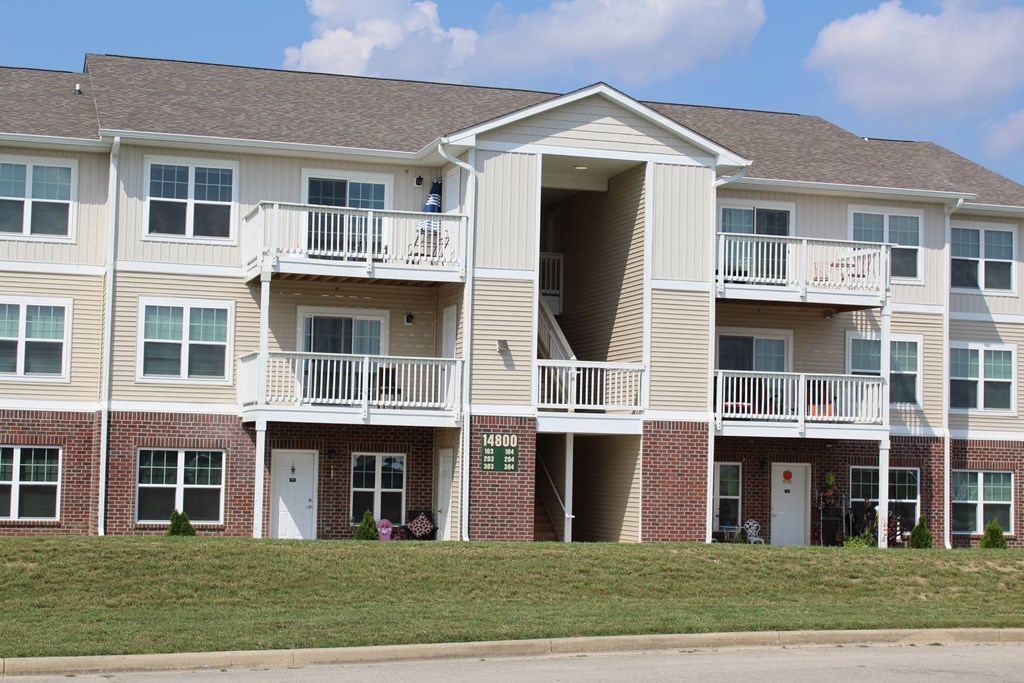 a building with two balconies and a lawn a building with two balconies and a lawn at Salem Place Apartments, Daleville, IN