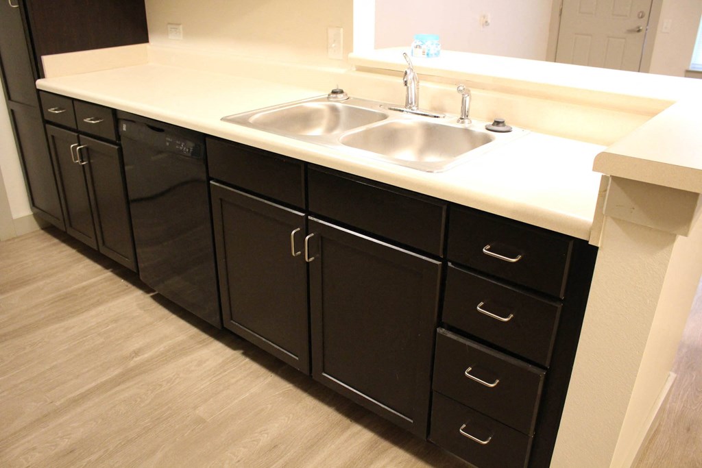 a kitchen with a stainless steel sink and cabinets at Salem Place Apartments, Indiana, 47334