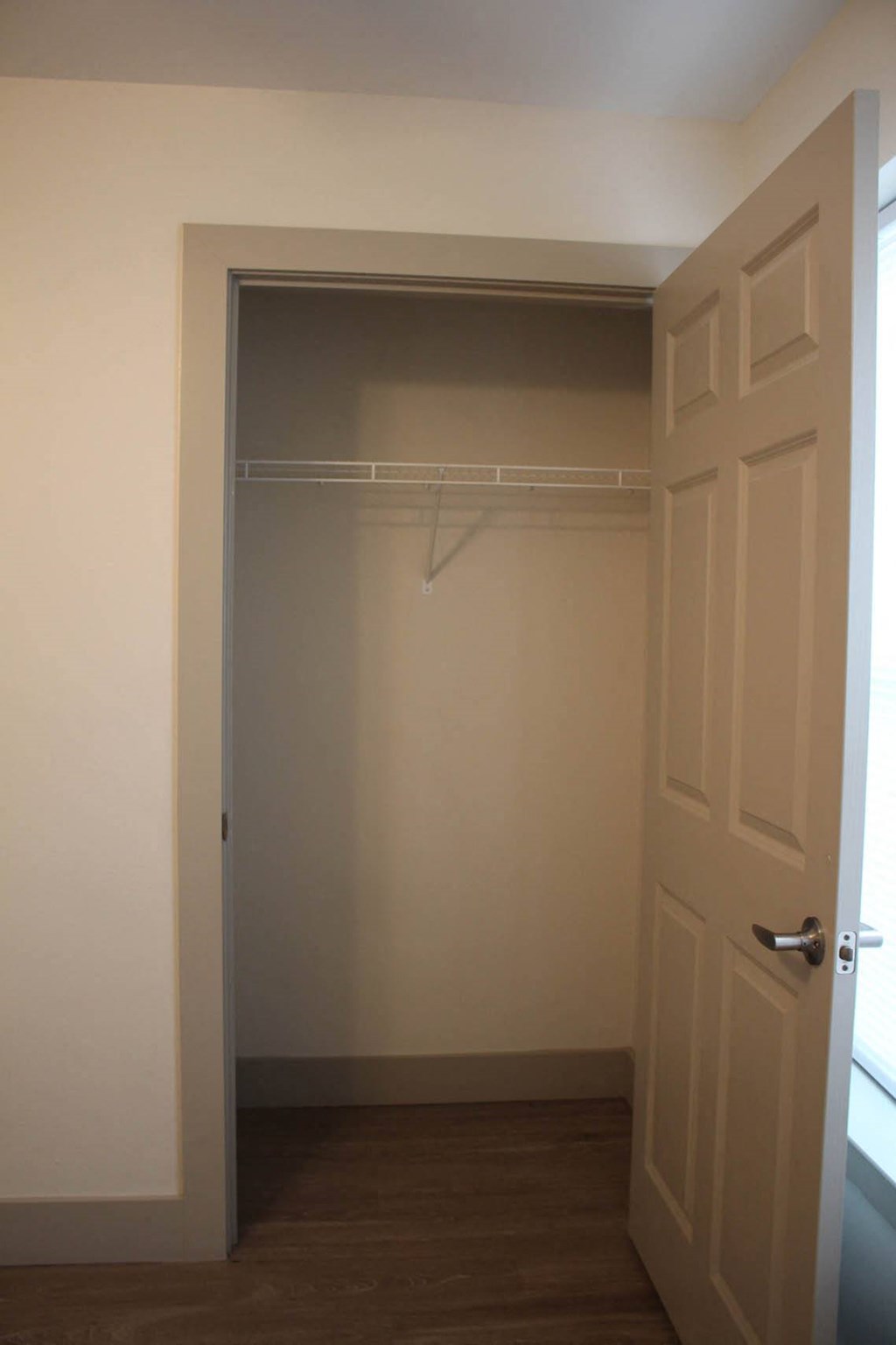a walk in closet with a white door and a hanger at Salem Place Apartments, Daleville, 47334