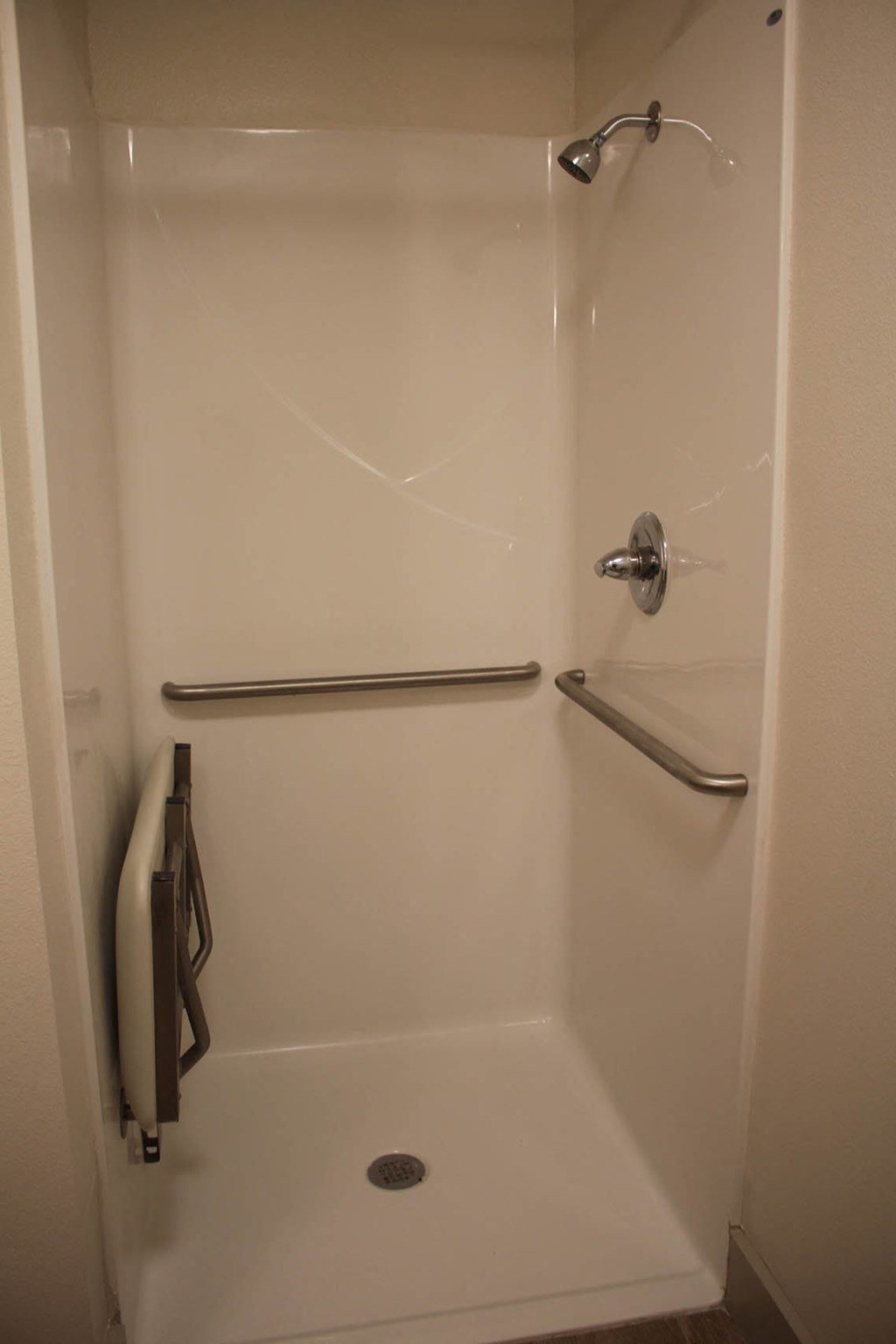 a walk in shower in a hotel room at Salem Place Apartments, Indiana