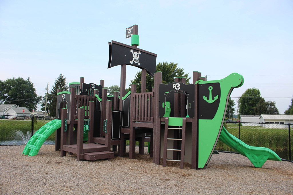 a playground with a mix of wooden structures and green and brown equipment a playground with a mix of wooden structures and green and brown equipment at Salem Place Apartments, Daleville, 47334