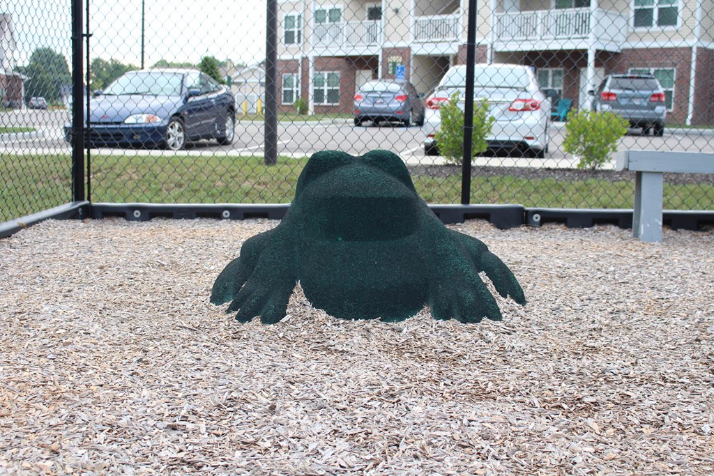a statue of a hand in front of a fence a statue of a hand in front of a fence at Salem Place Apartments, Daleville, Indiana
