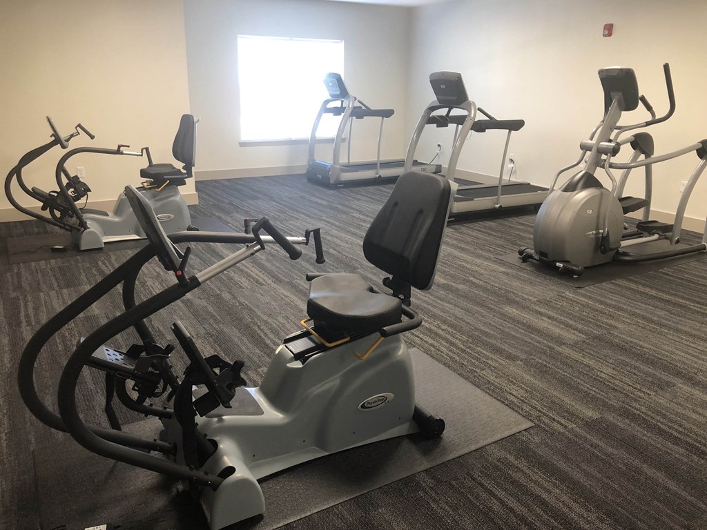 a gym with several exercise machines in it