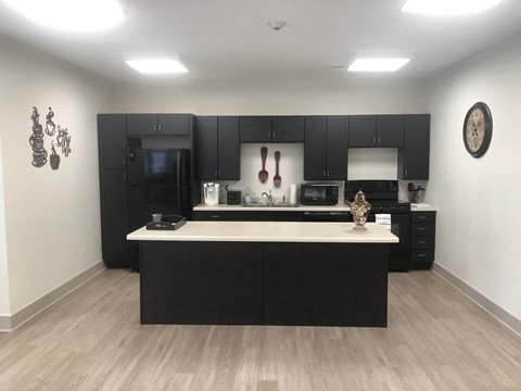 a kitchen with black cabinets and a white counter top