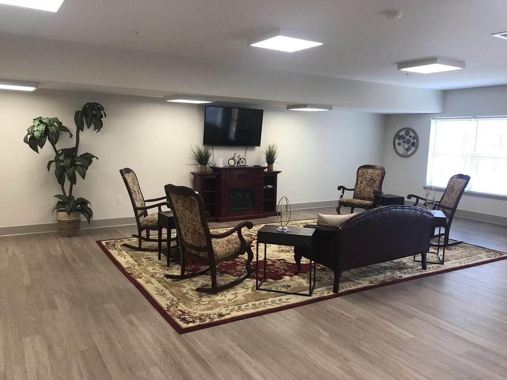 a living room with a table and chairs and a tv  at Lake Park Market Apartments, Hobart, 46342