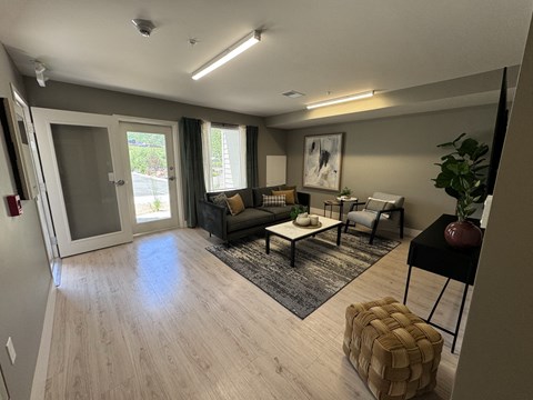 a living room with a wooden floor and a couch and a table