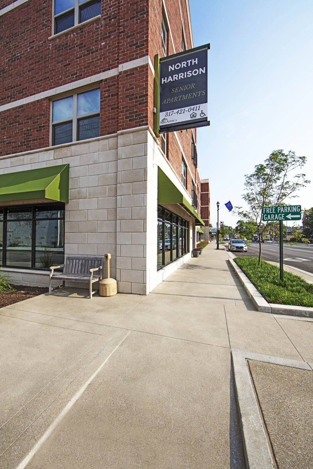 a sidewalk in front of a building with a sign  at North Harrison Senior Apts, Indiana, 46176