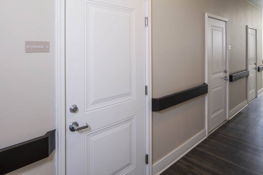 a door is open in a hallway with white walls and wood floors  at North Harrison Senior Apts, Shelbyville, IN, 46176