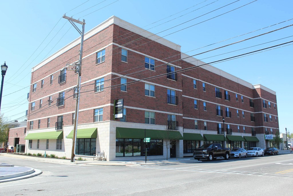 a brick building with green awnings on the corner of a street  at North Harrison Senior Apts, Shelbyville, IN, 46176