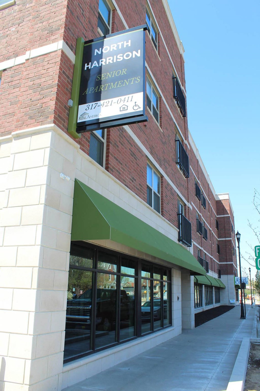 the front of a building with a sign for a hair salon  at North Harrison Senior Apts, Shelbyville, IN