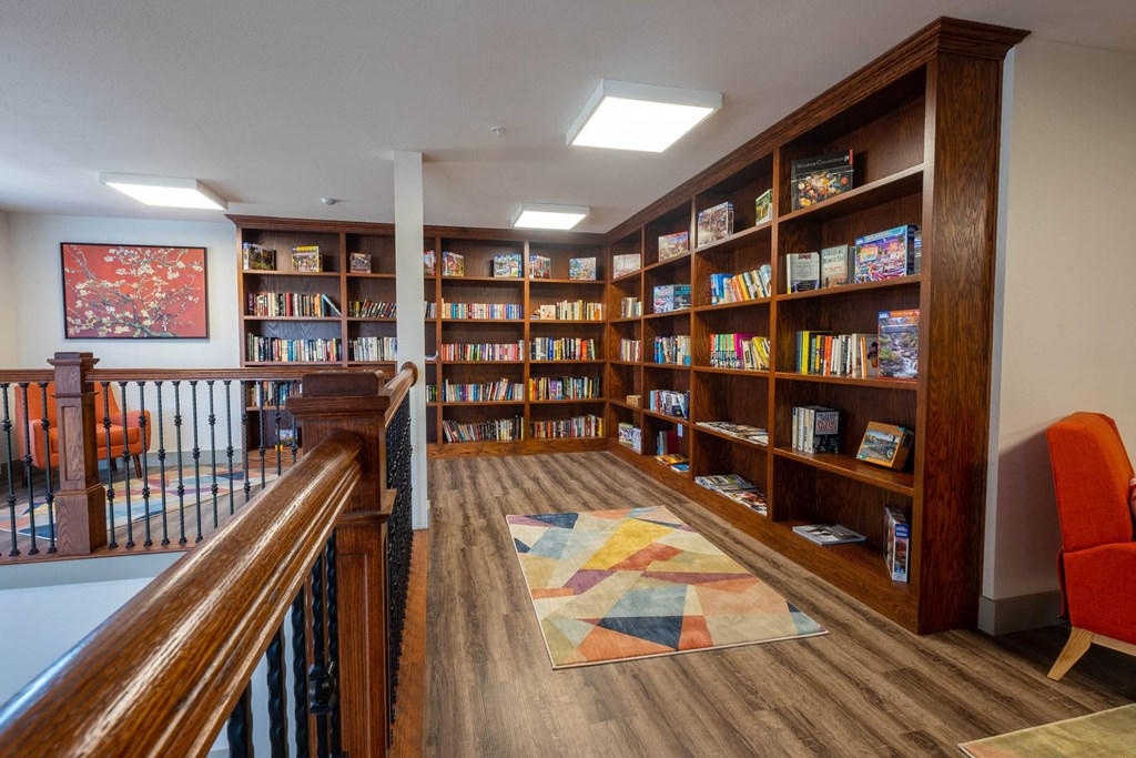 a library in a home with wooden shelves and a staircase at Ritchey Reserve, Fishers, Indiana