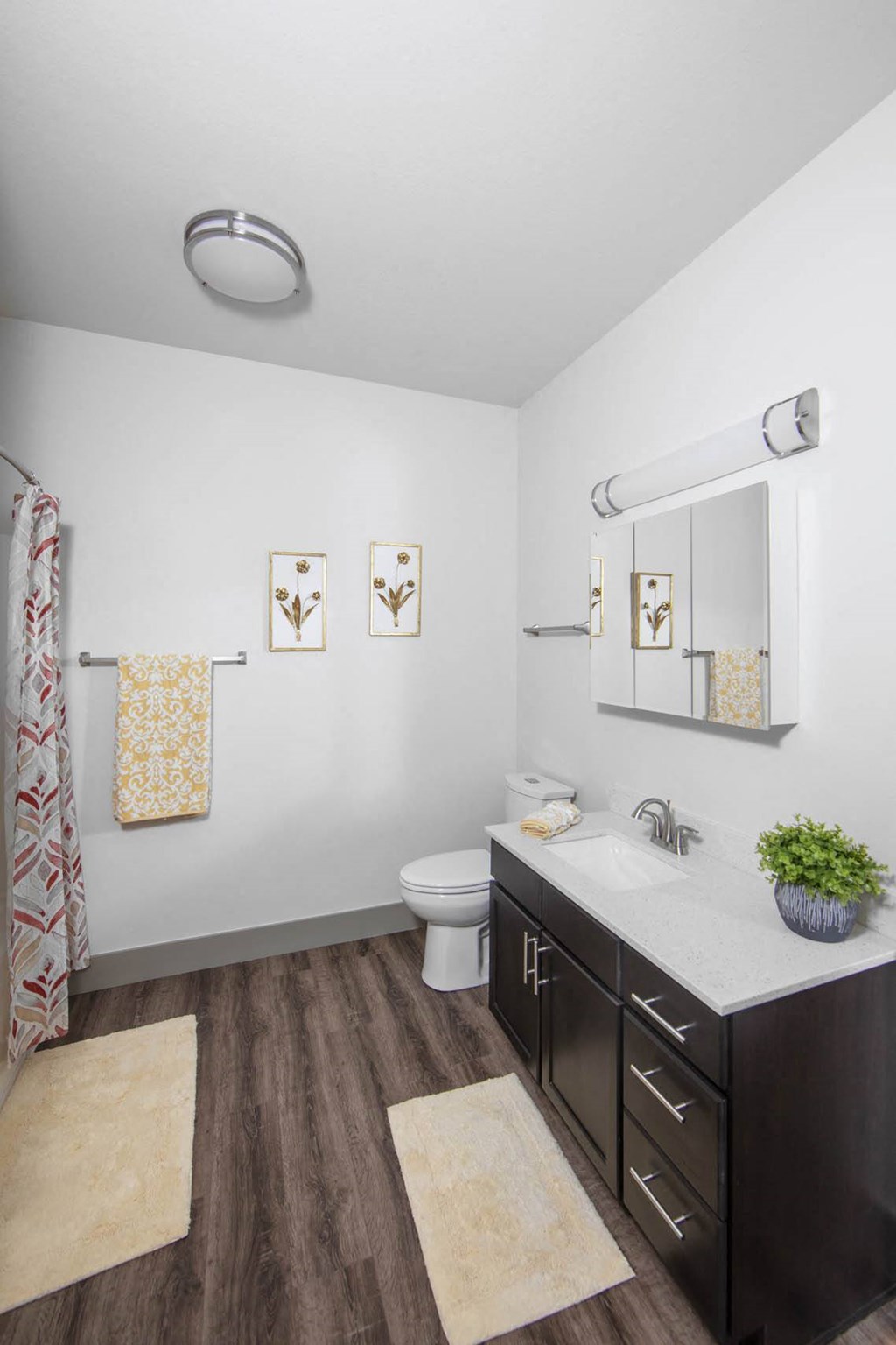 a bathroom with a sink and a toilet and a mirror at Ritchey Reserve, Fishers, Indiana
