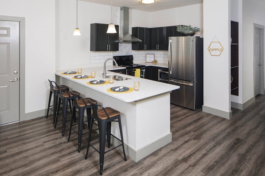 a kitchen with a large island and black appliances at Ritchey Reserve, Fishers, Indiana