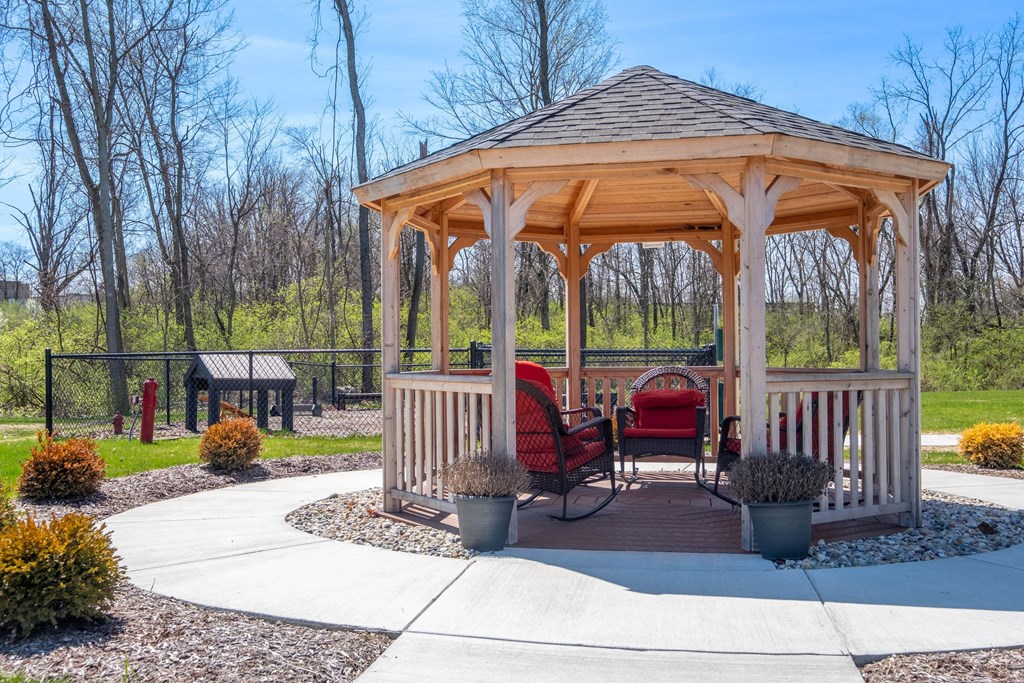 a gazebo with a table and chairs in a park at Ritchey Reserve, Fishers, 46038