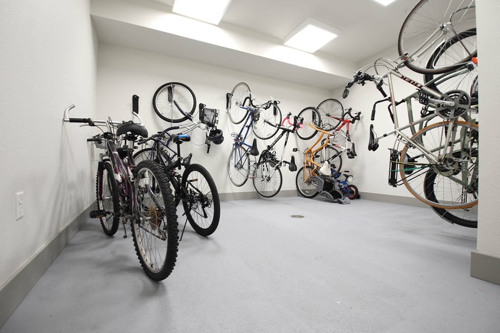 a group of bikes hanging on the wall in a white room at SouthPointe Village Apartments, LP, Fishers, 46038