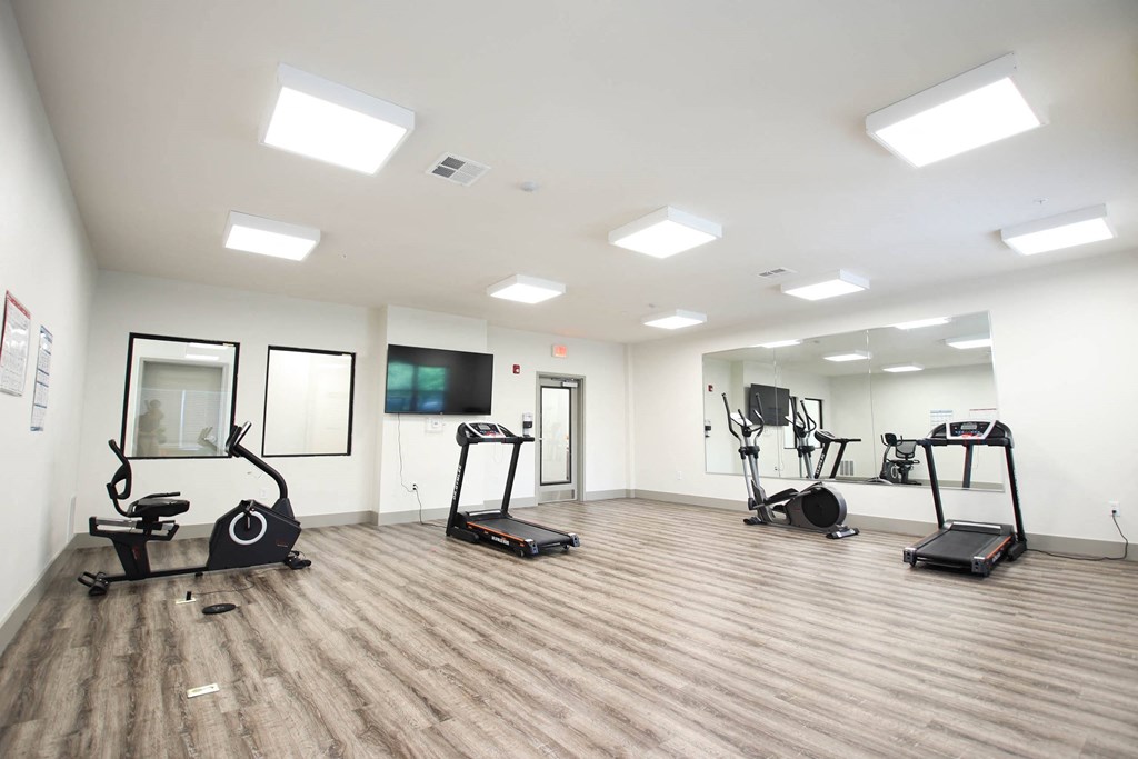 a gym with cardio machines and weights on the floor at SouthPointe Village Apartments, LP, Fishers, Indiana