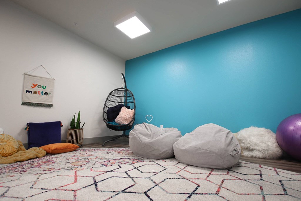 a room with pillows on the floor and a blue wall at SouthPointe Village Apartments, LP, Indiana