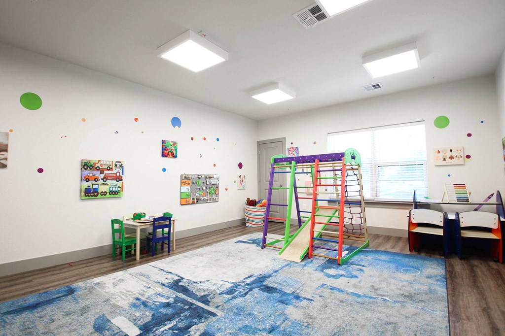 a play room with a ladder and a rug in front of a window at SouthPointe Village Apartments, LP, Fishers, IN, 46038