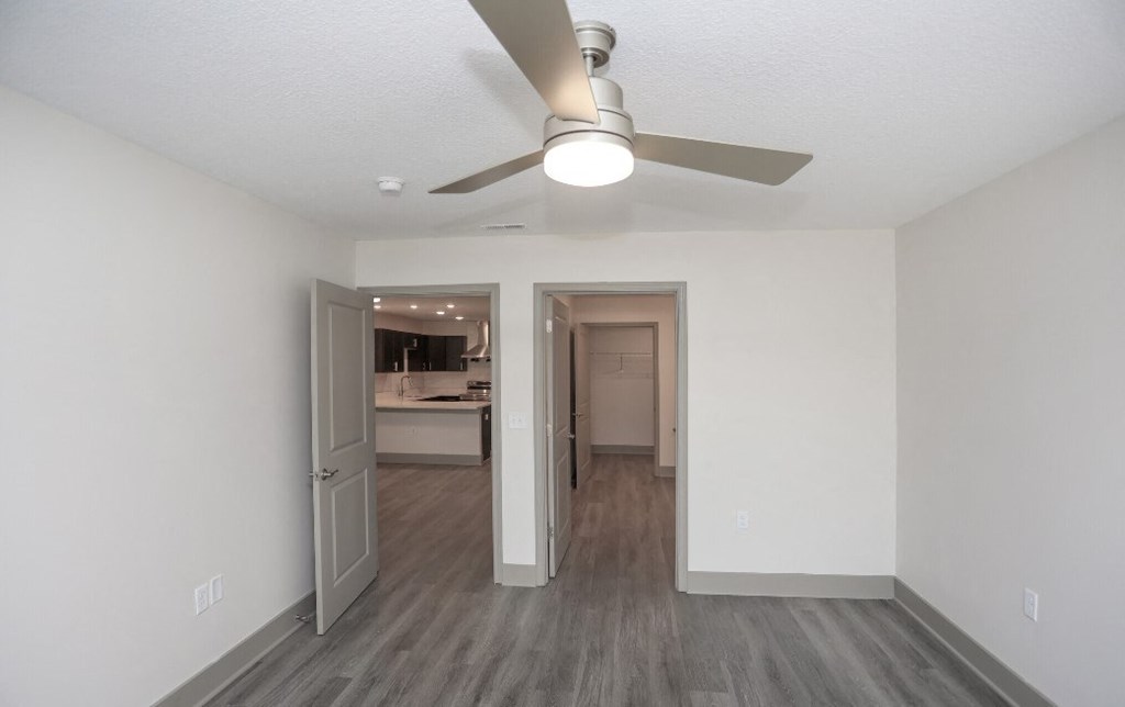 an open living room and kitchen with a ceiling fan