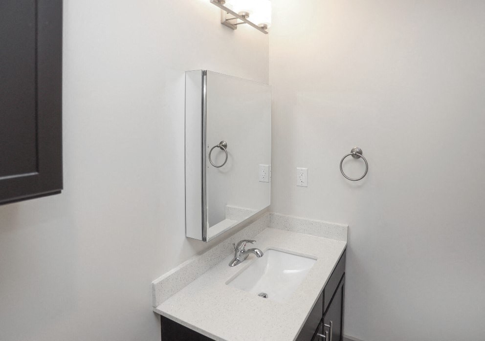 an empty bathroom with a sink and a mirror