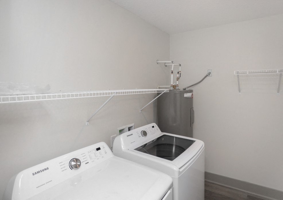 an empty laundry room with a washing machine and a dryer an empty laundry room with a washing machine and a dryer at Morada at Maysville, Fort Wayne, 46815