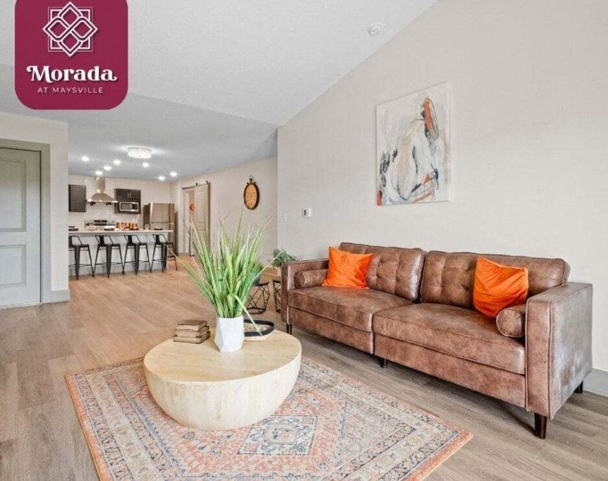 a living room with a couch and a coffee table at Morada at Maysville, Fort Wayne, IN