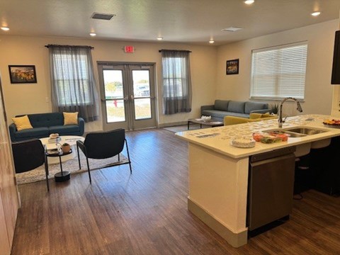 A kitchen area with a dining table and chairs.