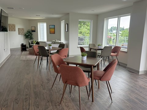A dining room with a long table and chairs.