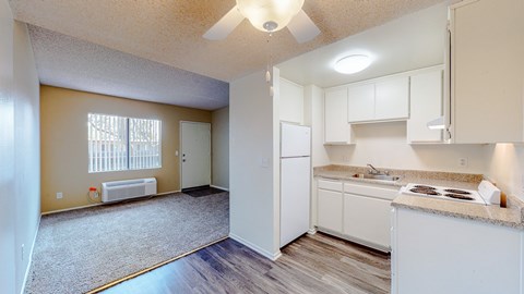 A kitchen with white cabinets and a countertop.
