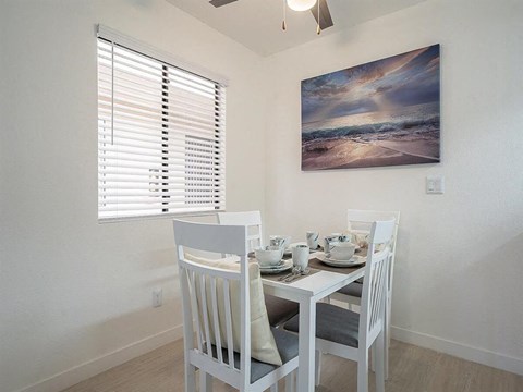 a dining room with a table and chairs and a window