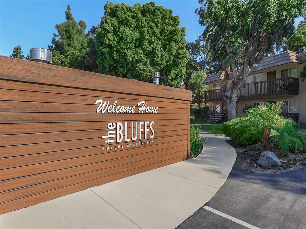 a wooden fence with a welcome sign on it