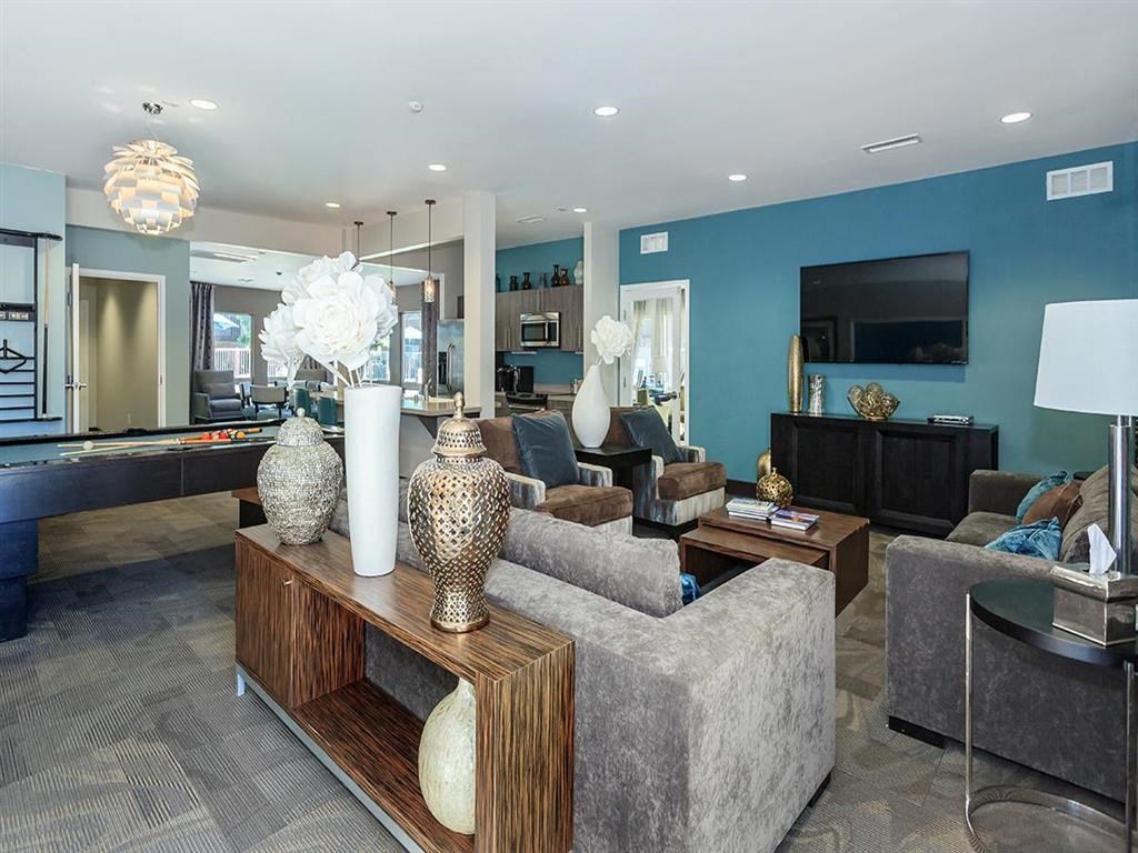 a living room with couches and chairs and a television