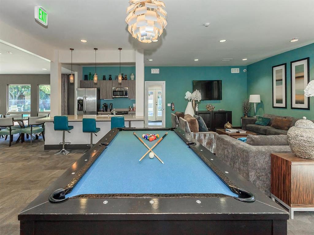 a pool table in the center of a living room