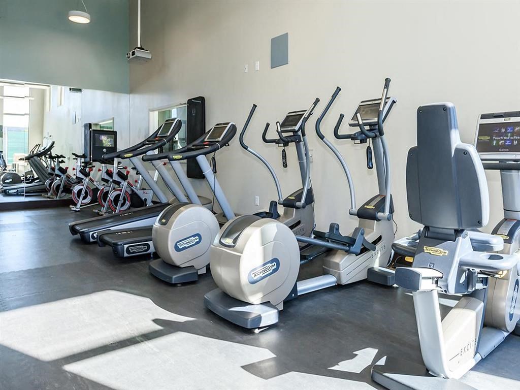 a gym with various exercise equipment in it