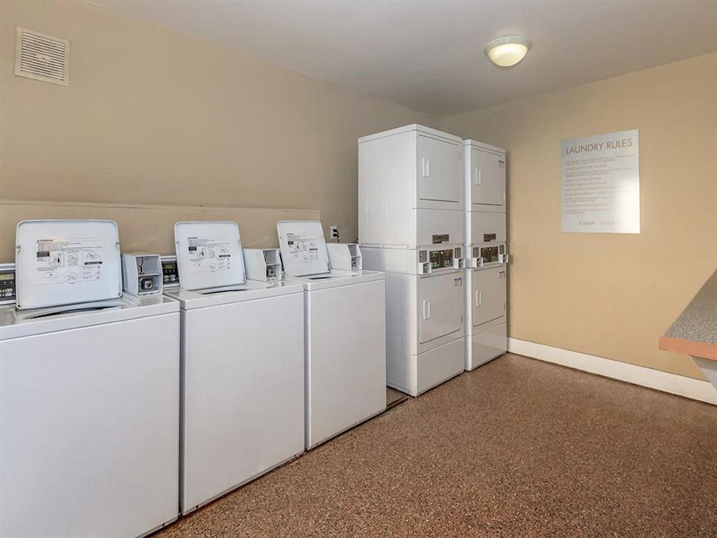 a group of white refrigerators in a room