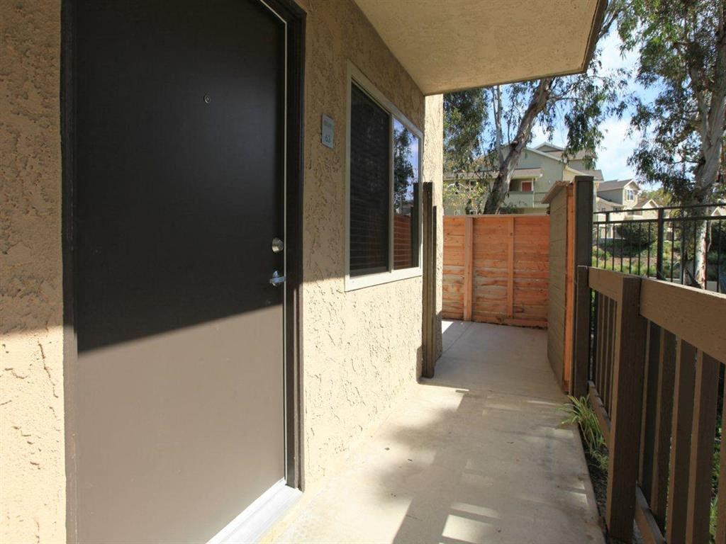 the door to the patio of a house with a wooden fence