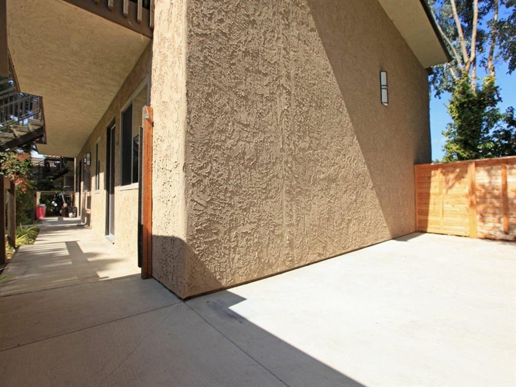 a building with a long porch and a sidewalk