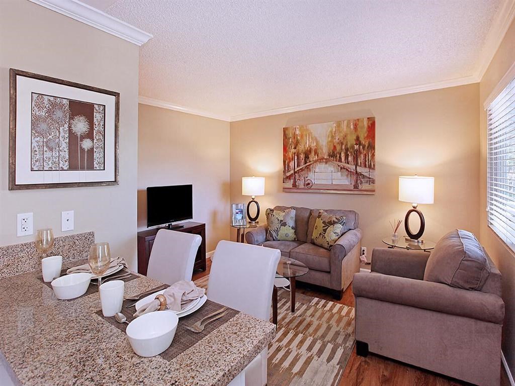 a living room and dining room with a couch and a table