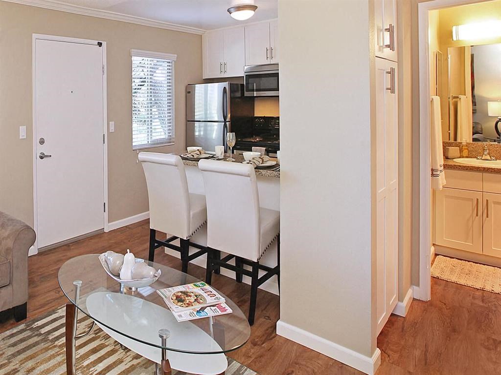 a living room with a kitchen and a table