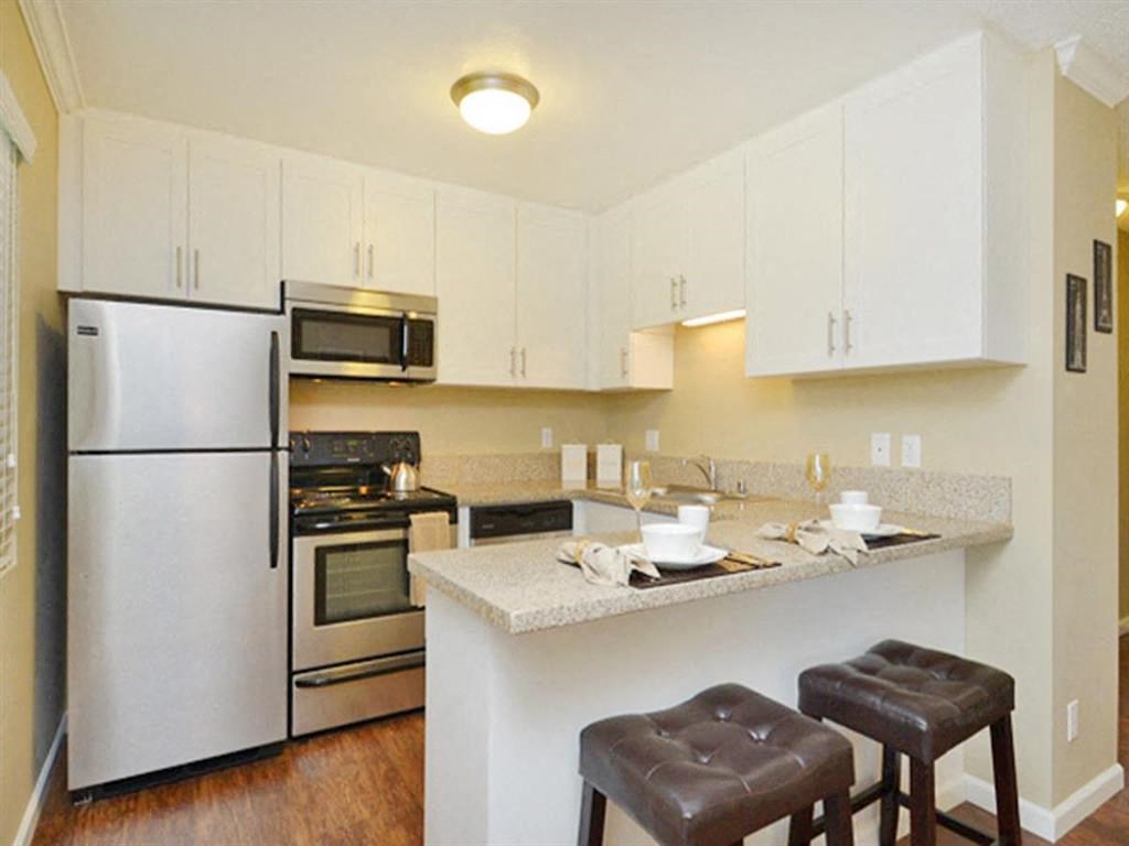 a kitchen with a counter top and a refrigerator